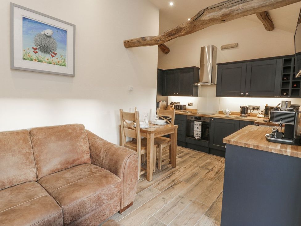 A kitchenette with a dining table and chairs at Little Esklets in Whitby