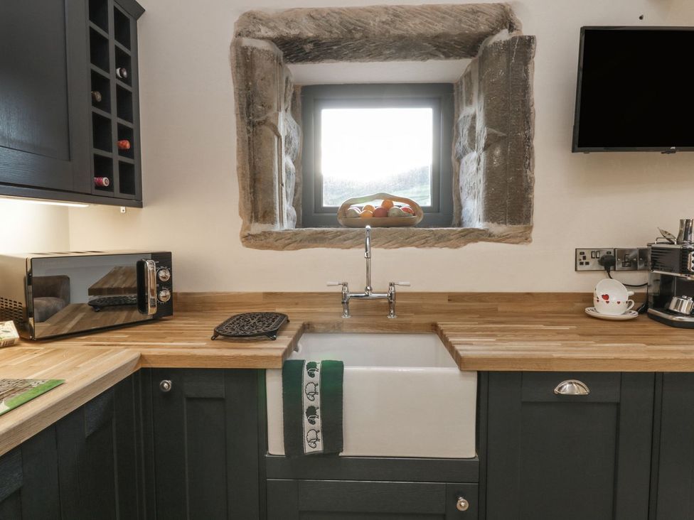 A kitchen with a sink and microwave at Little Esklets in Whitby