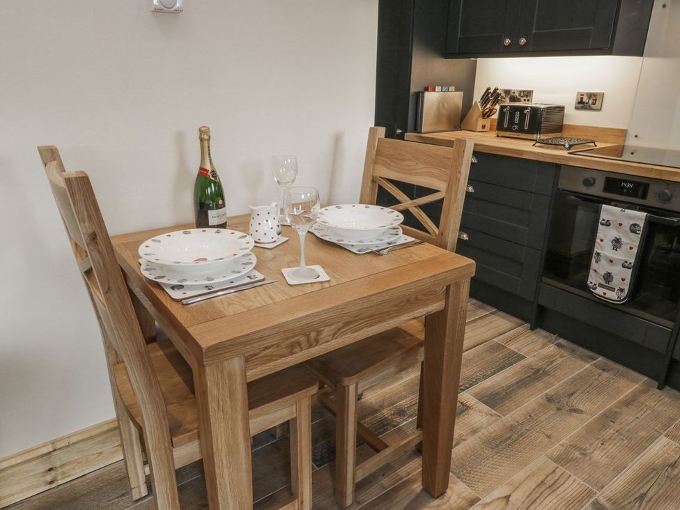 A dining table set with plates and glasses at Little Esklets in Whitby