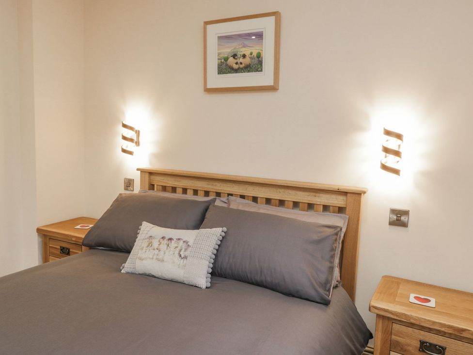 A bedroom with a bed and nightstand at Little Esklets in Whitby