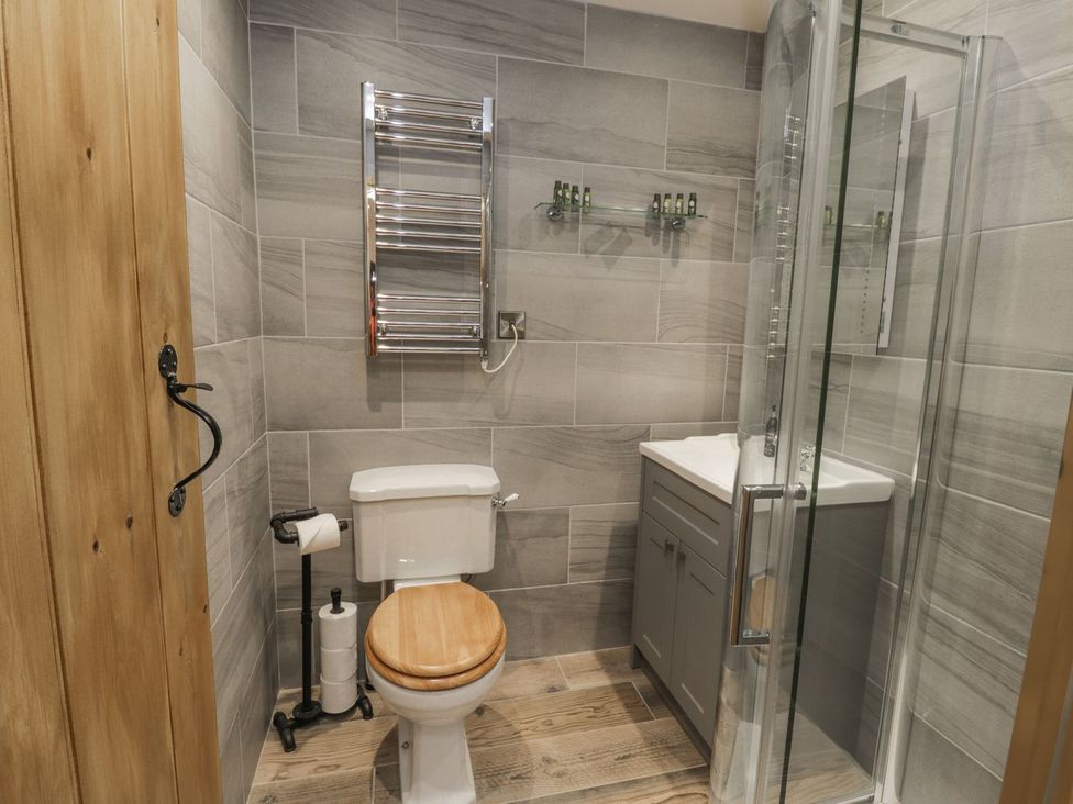 A bathroom with a toilet, sink, and shower at Little Esklets in Whitby