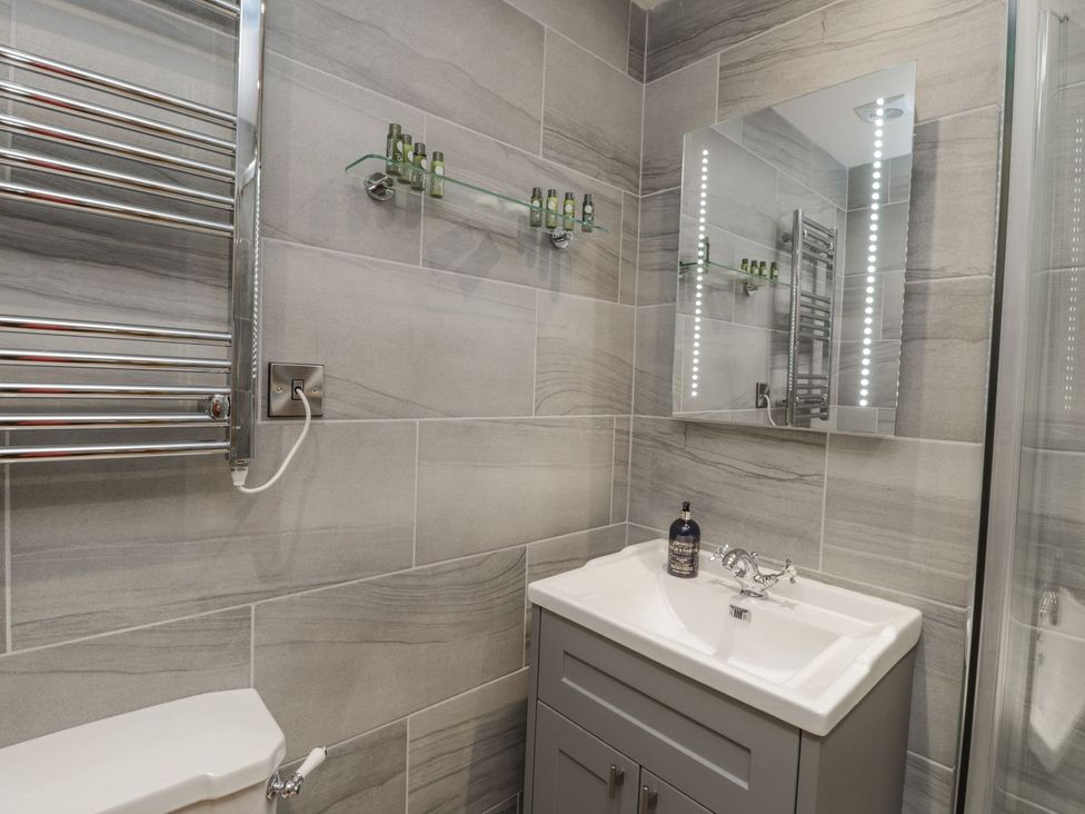 A bathroom with a sink, toilet, and towel radiator at Little Esklets in Whitby