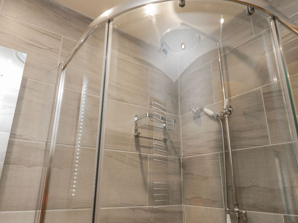 A shower with a glass door at Little Esklets in Whitby