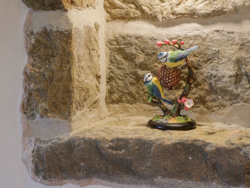 A decorative shelf with bird figurines at Little Esklets in Whitby