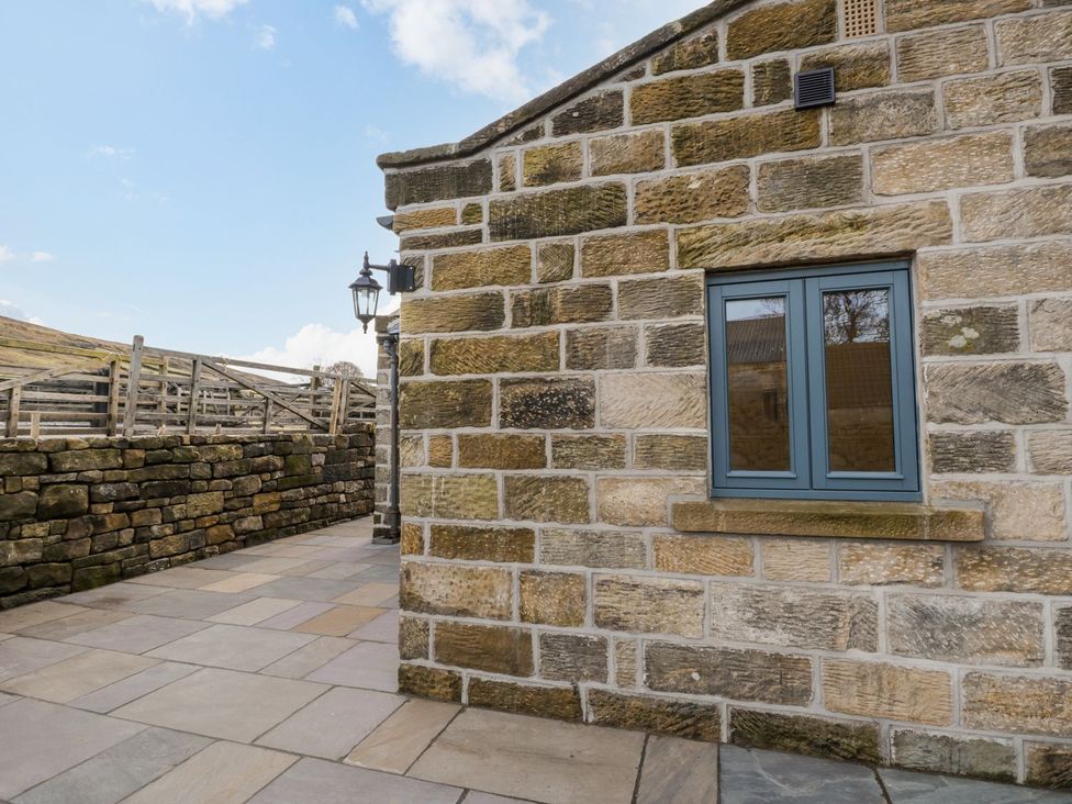 A stone wall with a window and lamp post at Little Esklets in Whitby