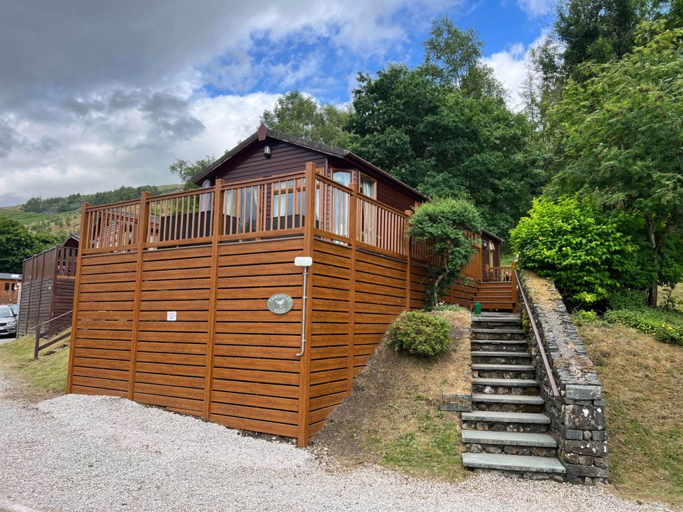 A lodge with decking and steps leading up to it at 2 Bed Lodge-Sleeps 4-stunning views -Pet Friendly in Troutbeck