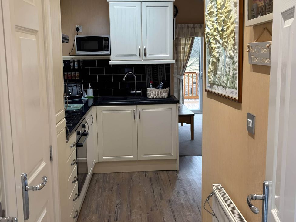 A kitchen with cabinets and appliances at 2 Bed Lodge-Sleeps 4-stunning views -Pet Friendly, Troutbeck