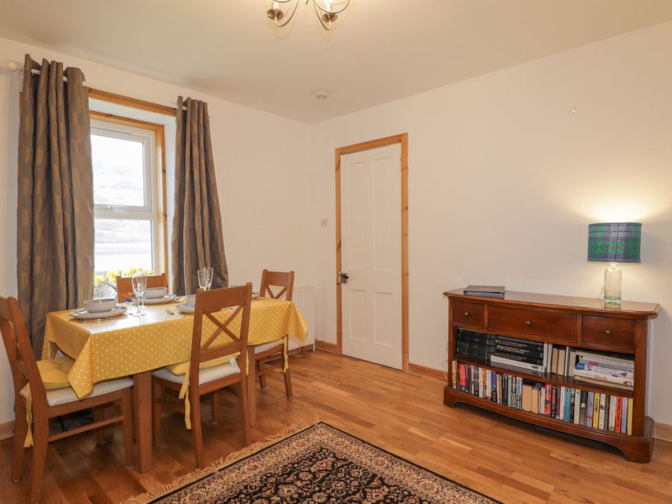 A dining room with a table and chairs at Tigh a Phailean in Kyle