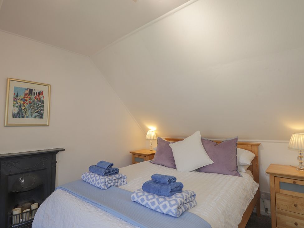 A bedroom with a bed and towels at Tigh a Phailean in Letterfearn
