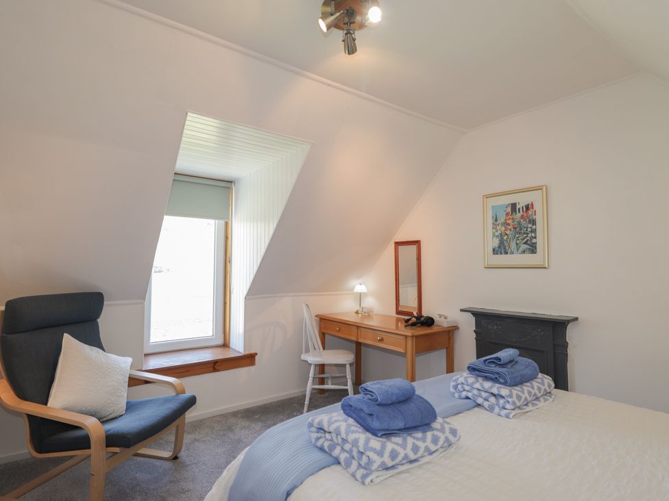 A bedroom with a bed and desk at Tigh a Phailean in Letterfearn