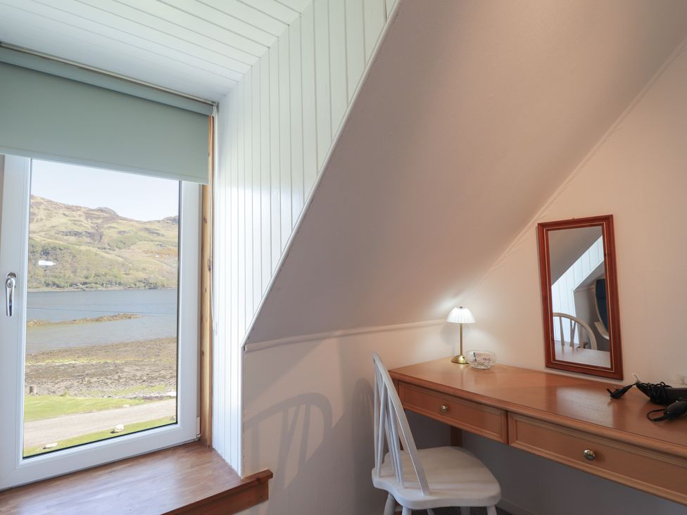A room with a desk and chair by a window at Tigh a Phailean in Letterfearn