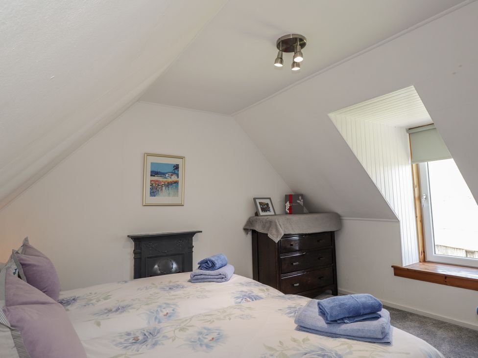 A bedroom with a bed and a dresser at Tigh a Phailean in Letterfearn