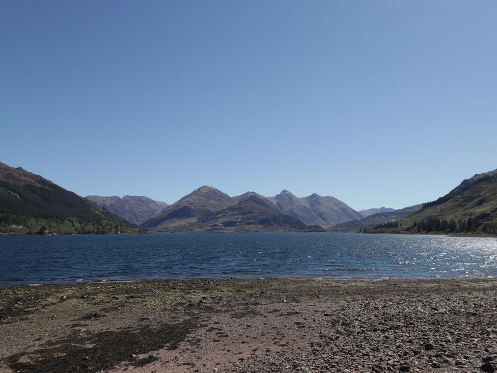 A lake with mountains in the background at Tigh a Phailean Letterfearn