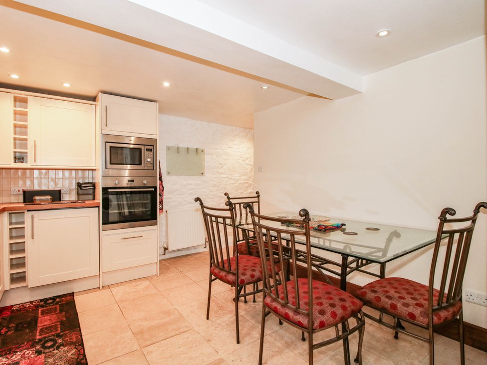 A kitchen with a table and chairs at Stone Cottage in Church Stretton