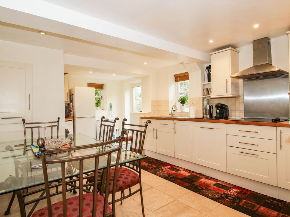 A kitchen with table and chairs at Stone Cottage in Church Stretton
