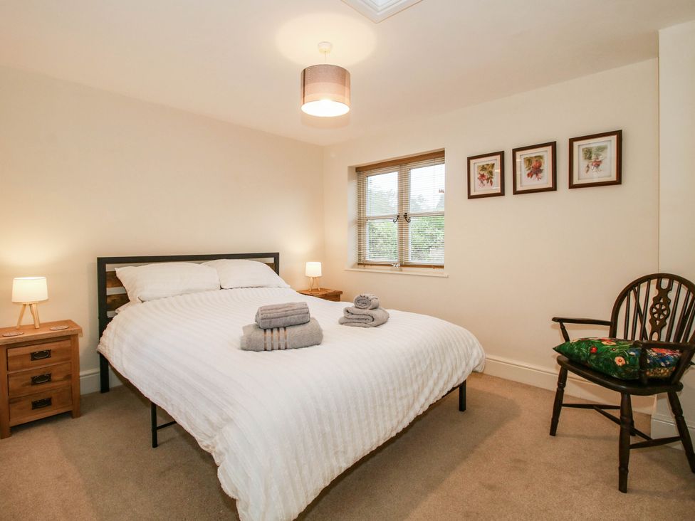 A bedroom with a bed and bedside tables at Stone Cottage in Church Stretton