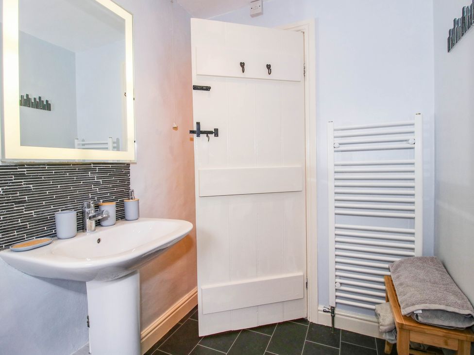A bathroom with a sink and mirror at Stone Cottage in Church Stretton