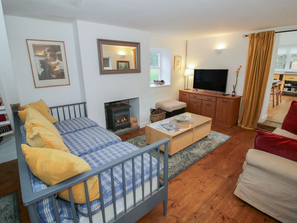 A living room with a fireplace and television at Ambercote Priors Marston near Southam
