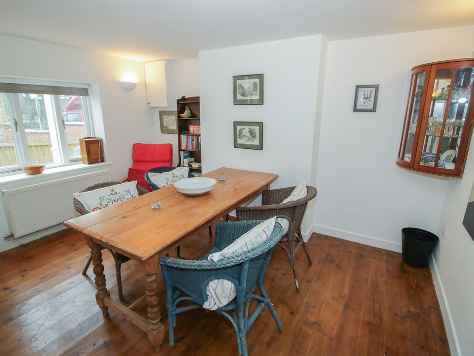 A dining room with a wooden table and chairs at Ambercote Priors Marston near Southam