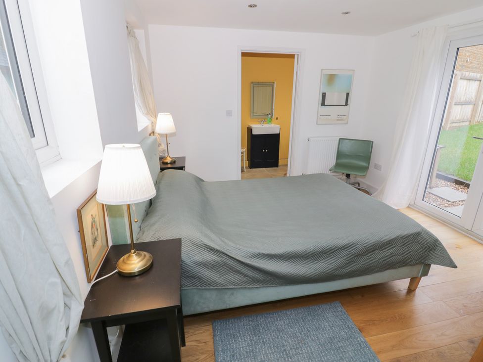 A bedroom with a bed and nightstands at Ambercote in Priors Marston near Southam