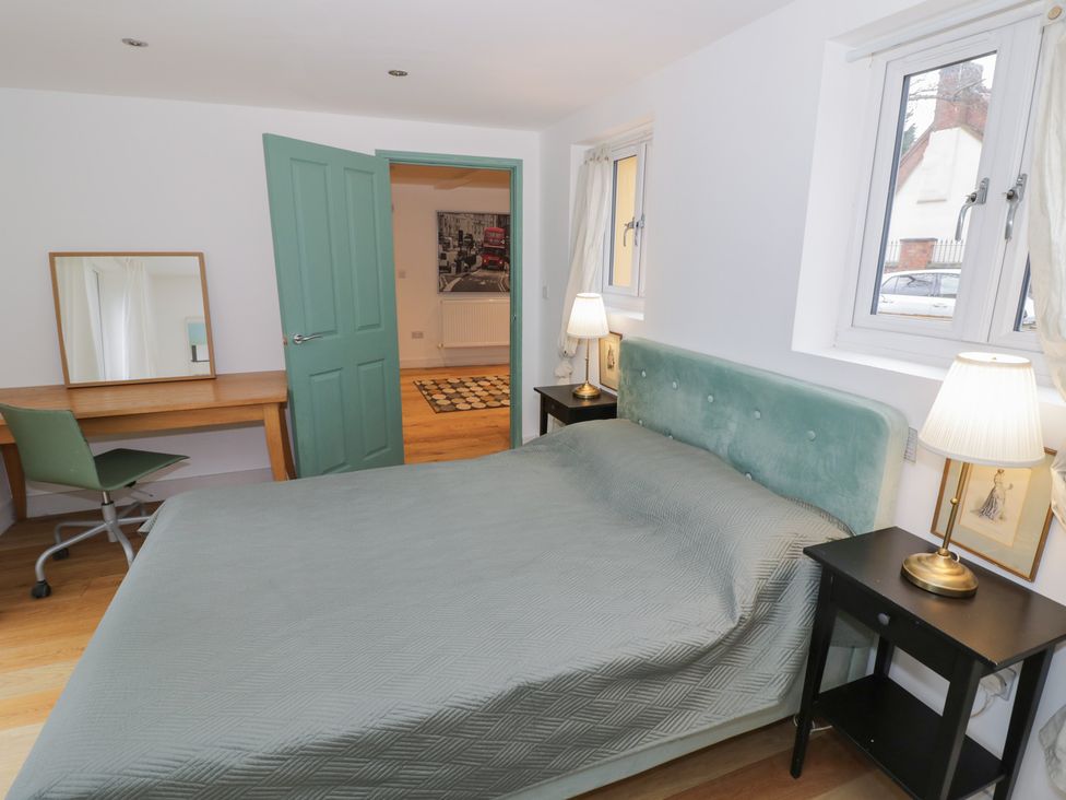 A bedroom with a bed, bedside tables and a desk at Ambercote Priors Marston near Southam