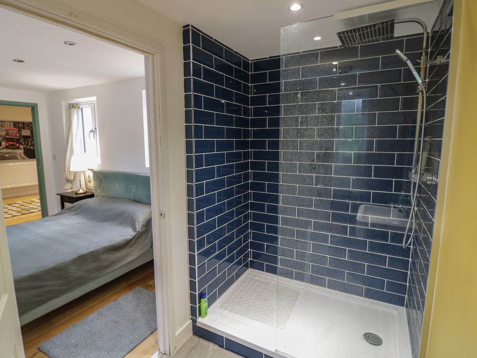 A bathroom with a shower and a view to a bedroom at Ambercote Priors Marston near Southam