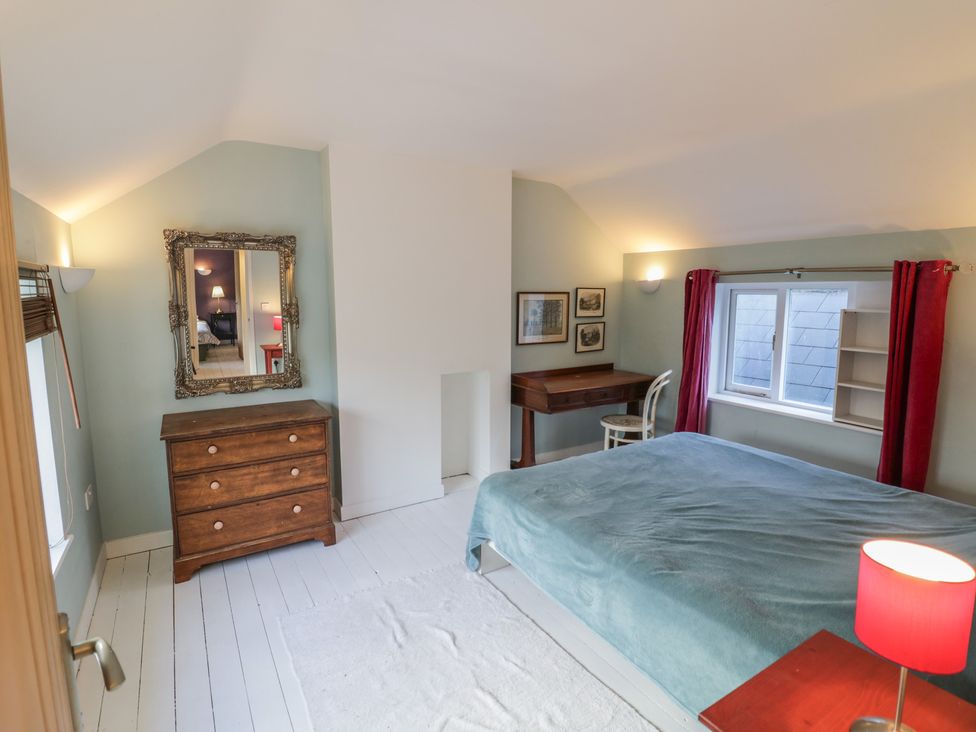 A bedroom with a bed and a dressing table at Ambercote Priors Marston near Southam