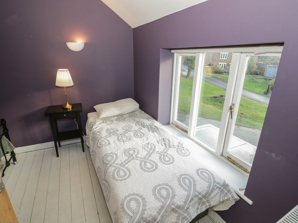 A bedroom with a bed and window in Ambercote Priors Marston near Southam