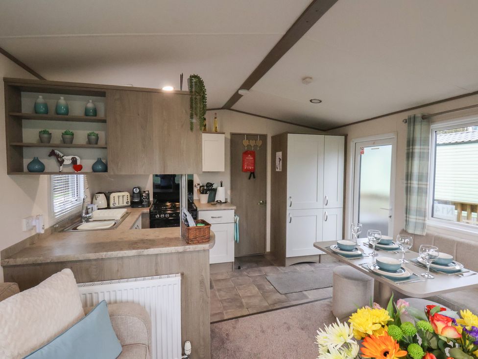 A kitchen with a dining table set at Pepper Pot Lodge in Knaresborough