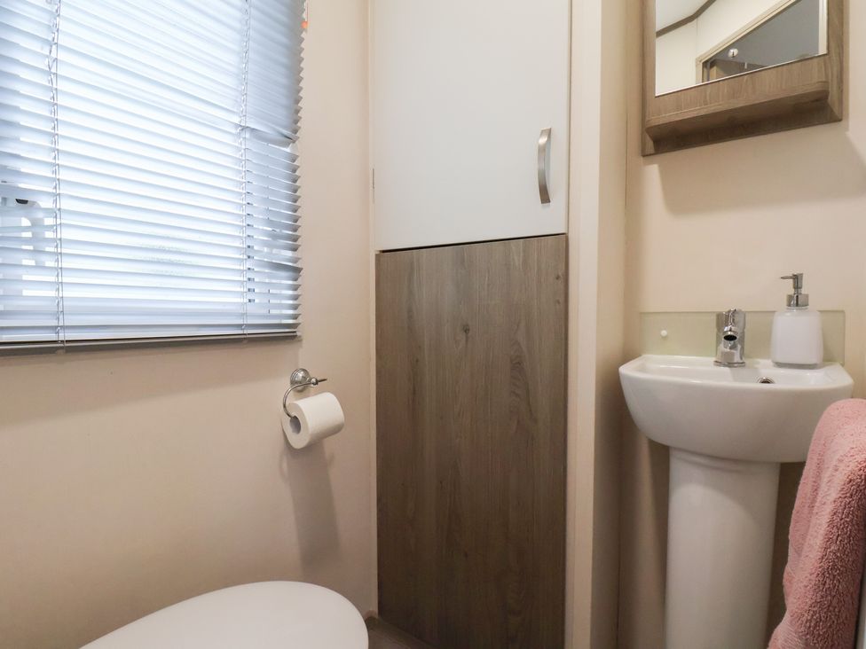 A bathroom with a sink and toilet at Pepper Pot Lodge in Knaresborough