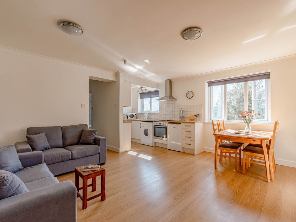 A living room with a sofa and dining table at Luxury 2 Bed Room Lake View Apt Bowness Parking Bowness-On-Windermere