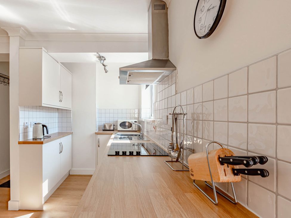 A kitchen with cabinets, a counter, and appliances at Luxury 2 Bed Room Lake View Apt Bowness Parking Bowness-On-Windermere