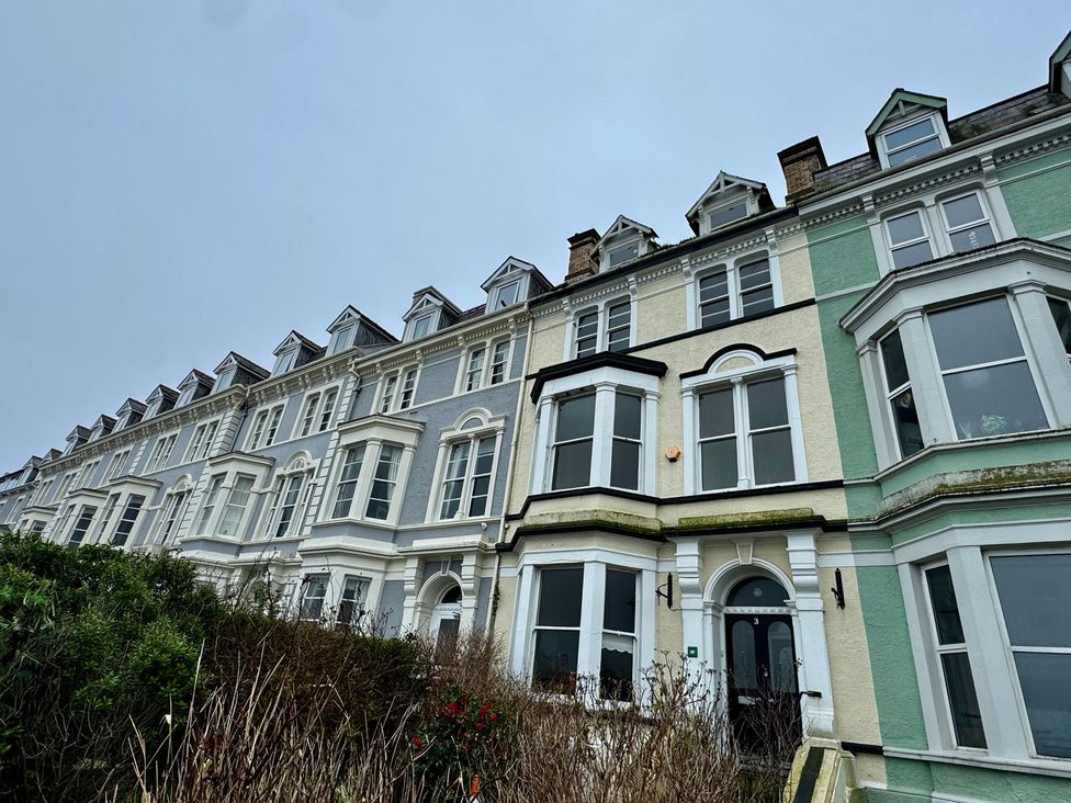 A row of houses with various colored facades at Sea View, East Parade, Llandudno
