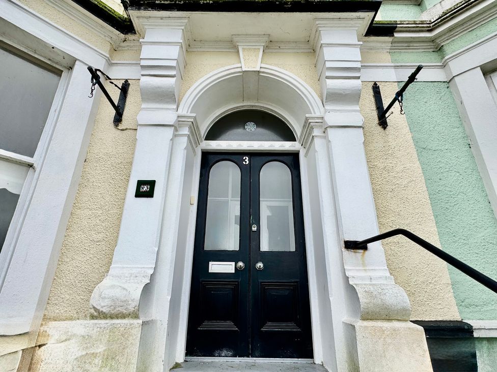 An entrance with a black door and number 3 at Sea View, East Parade in Llandudno