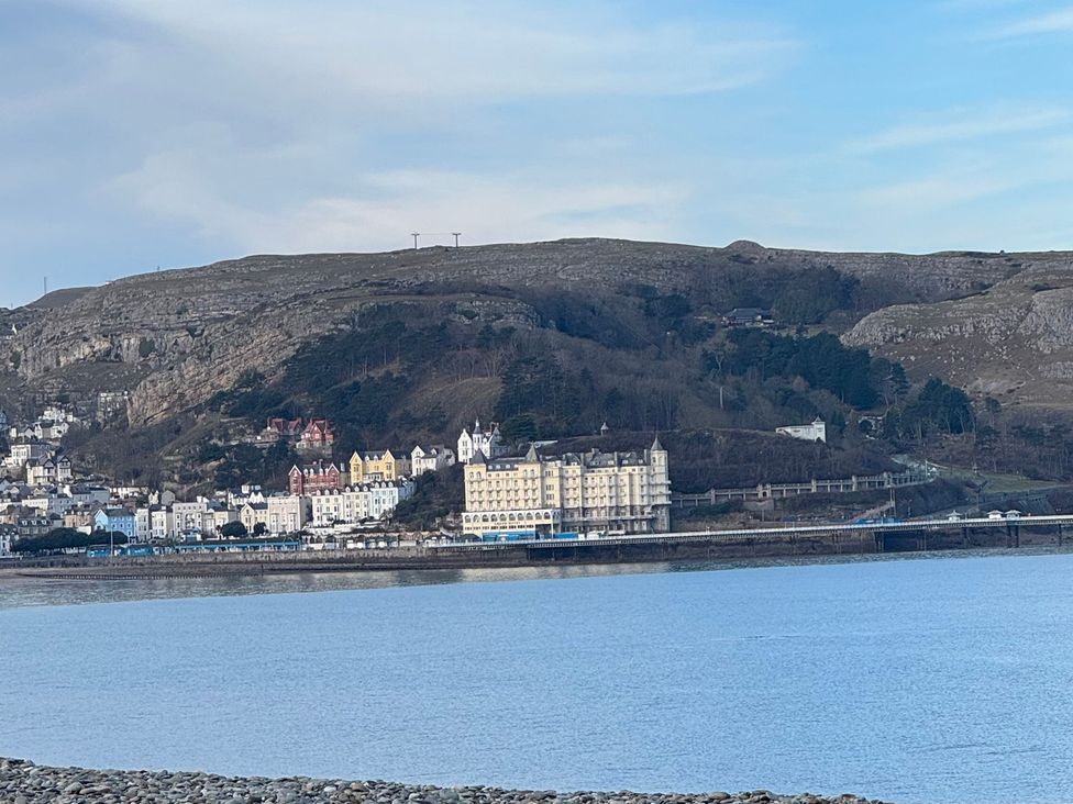 Buildings along the coastline with mountains in the background at Sea View, East Parade Llandudno