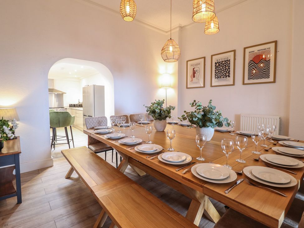 A dining room with a table set for dinner at Sea View, East Parade, Llandudno