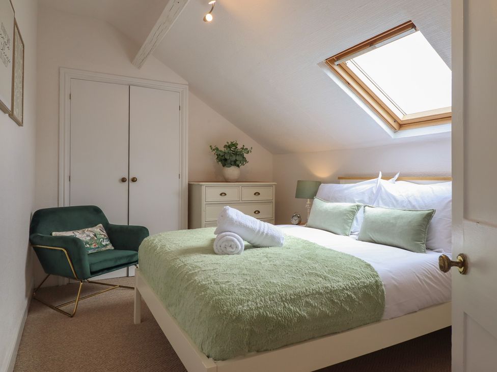 A bedroom with a double bed and wardrobe at Sea View, East Parade, Llandudno