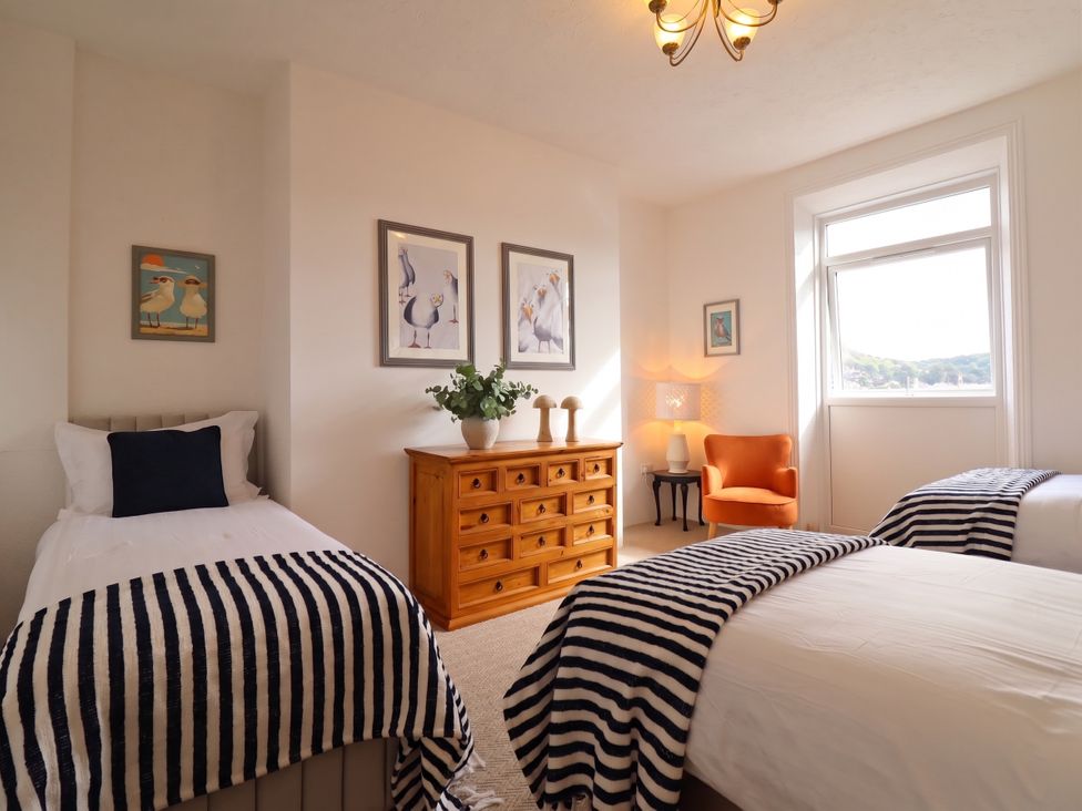 A bedroom with two beds and a dresser at Sea View, East Parade Llandudno