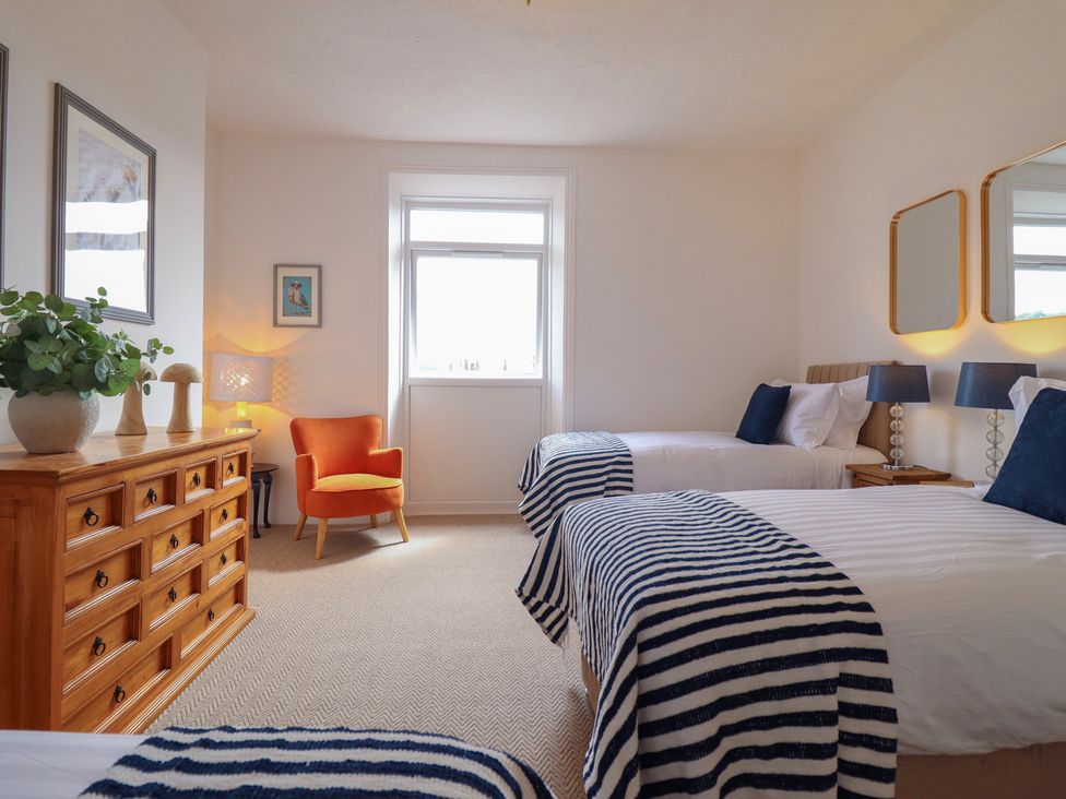 A bedroom with two beds and a dresser at Sea View, East Parade in Llandudno