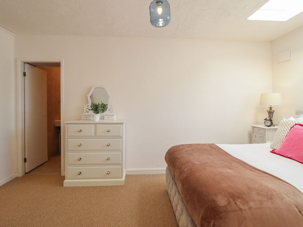 A bedroom with a bed and a dressing table at Sea View, East Parade in Llandudno