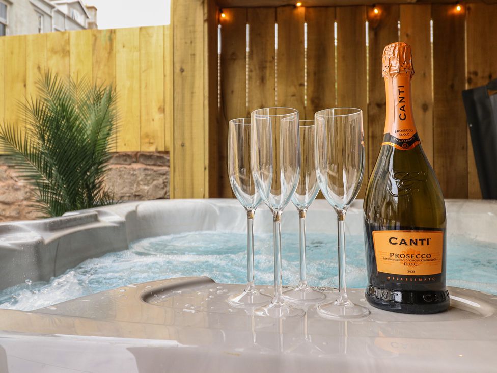 A hot tub with champagne glasses and a bottle at Sea View, East Parade Llandudno