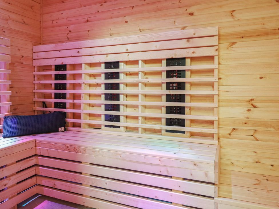 A sauna with wooden walls and heating panel at Sea View, East Parade in Llandudno