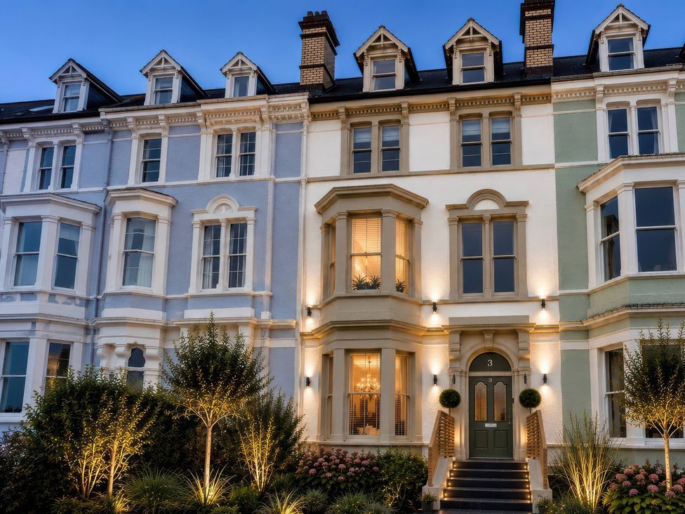 A house facade with windows, door, and plants at Sea View, East Parade, Llandudno