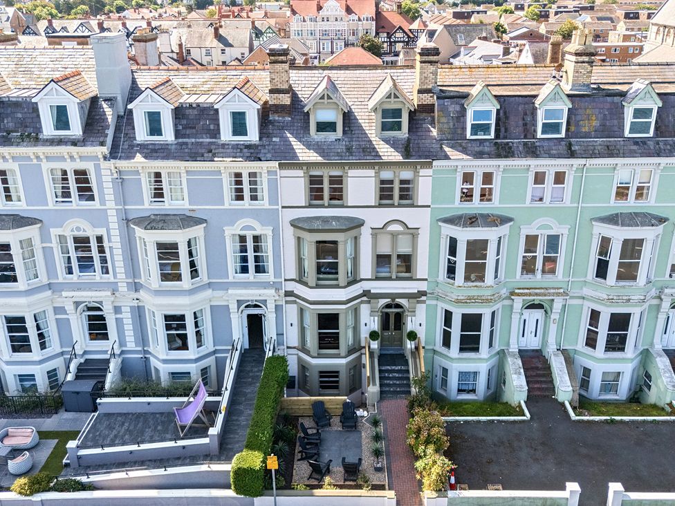A row of terraced houses with patios at Sea View, East Parade, Llandudno