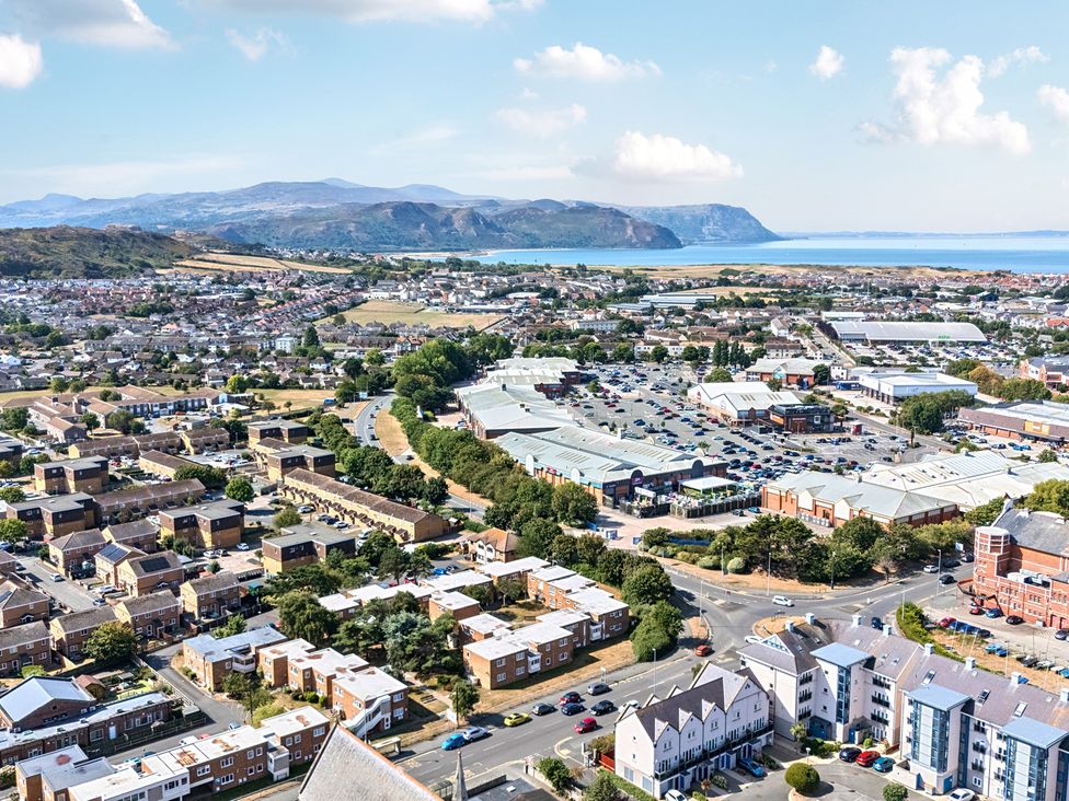 An aerial view of a town with houses, shops, and fields at Sea View, East Parade, Llandudno