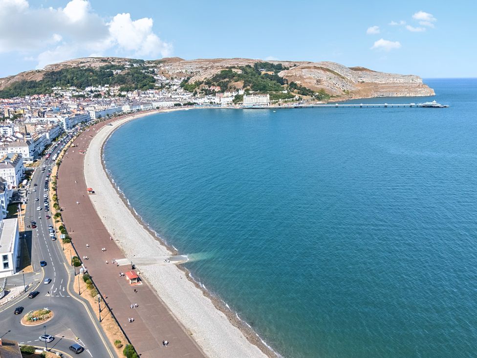 An aerial view of the coastline with a beach and buildings at Sea View, East Parade Llandudno
