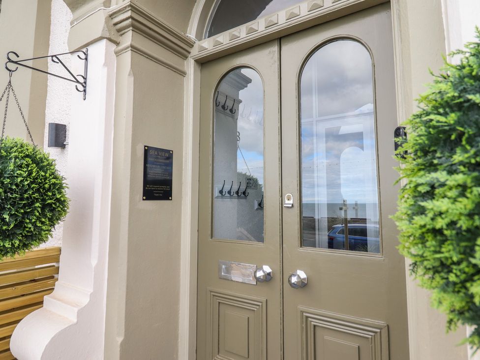 An entrance with a door and hanging plant at Sea View, Llandudno