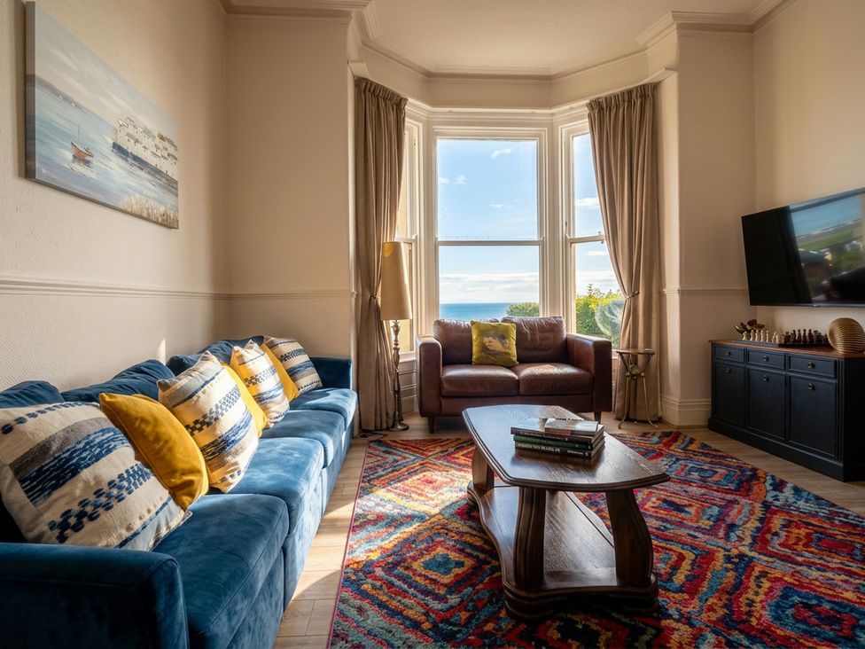 A living room with a sofa and coffee table at Sea View, East Parade in Llandudno