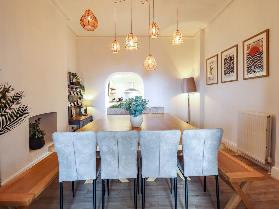 A dining room with a table and chairs at Sea View, East Parade in Llandudno