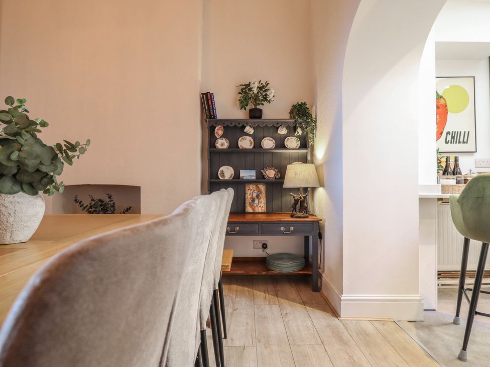 A dining room with a table and chairs at Sea View, East Parade Llandudno